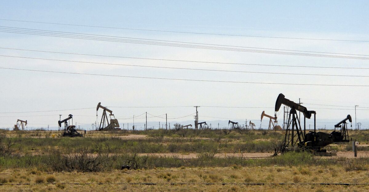 Oil rigs stand in the Loco Hills field near Artesia, N.M.