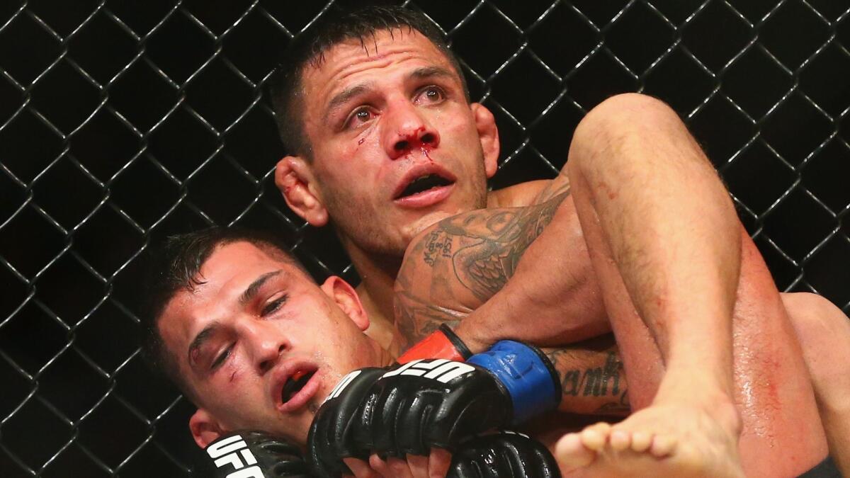 Rafael dos Anjos, top, fights Anthony Pettis during UFC 185 on March 14, 2015.