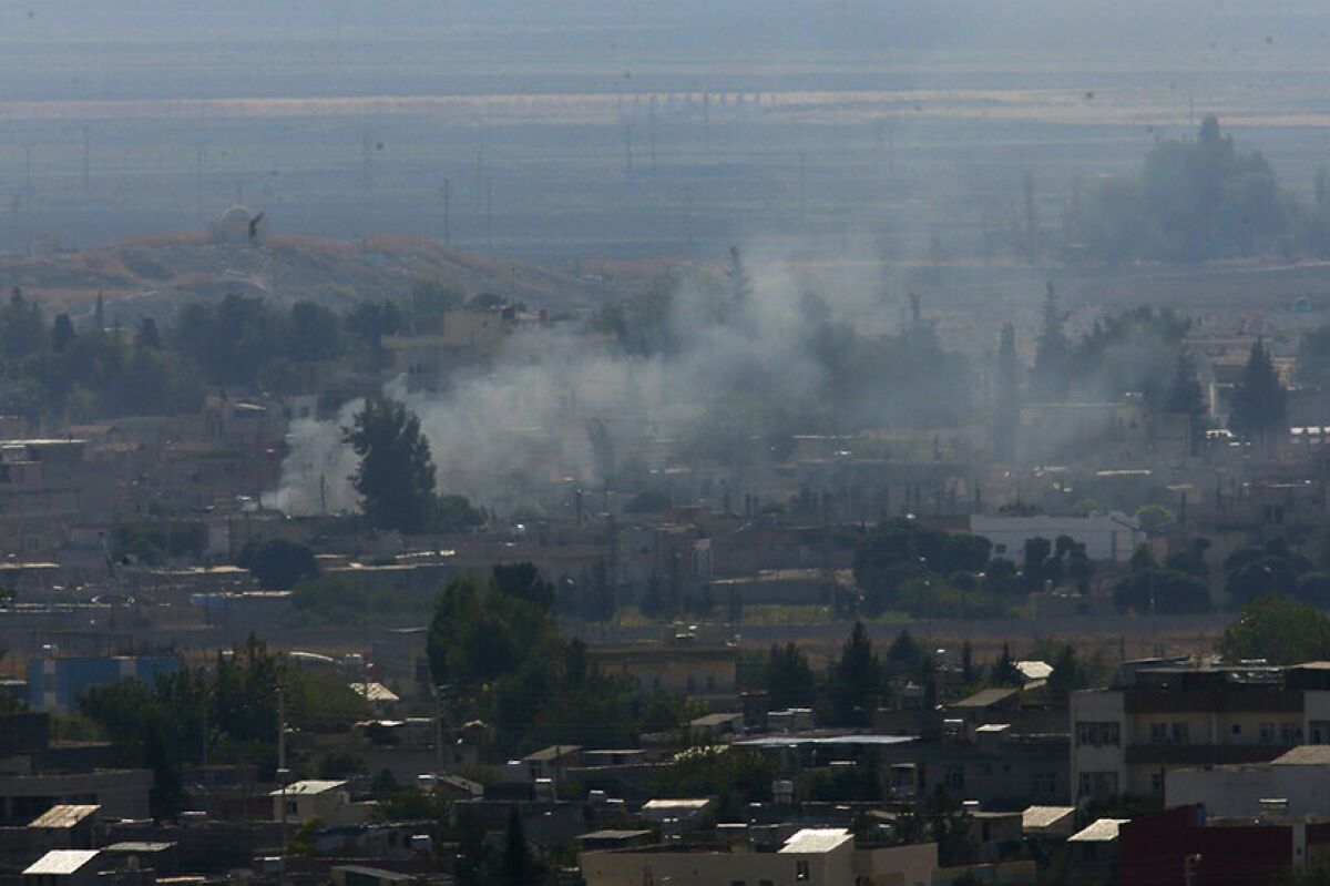 Smoke billows from targets in Ras al-Ayn, Syria, after shelling by Turkish forces Friday.