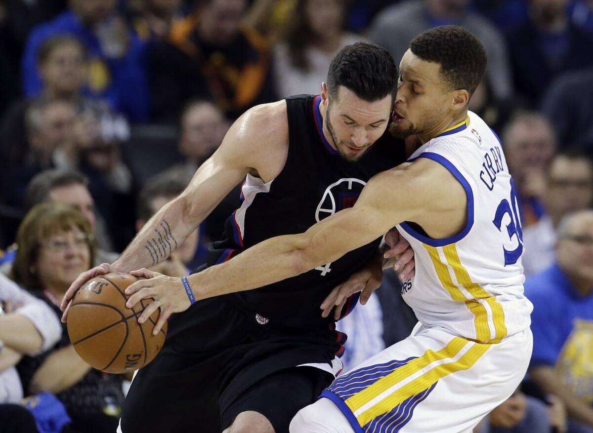 Warriors guard Stephen Curry (30) strips the ball from Clippers guard J.J. Redick during the second half of a game on Mar. 23.