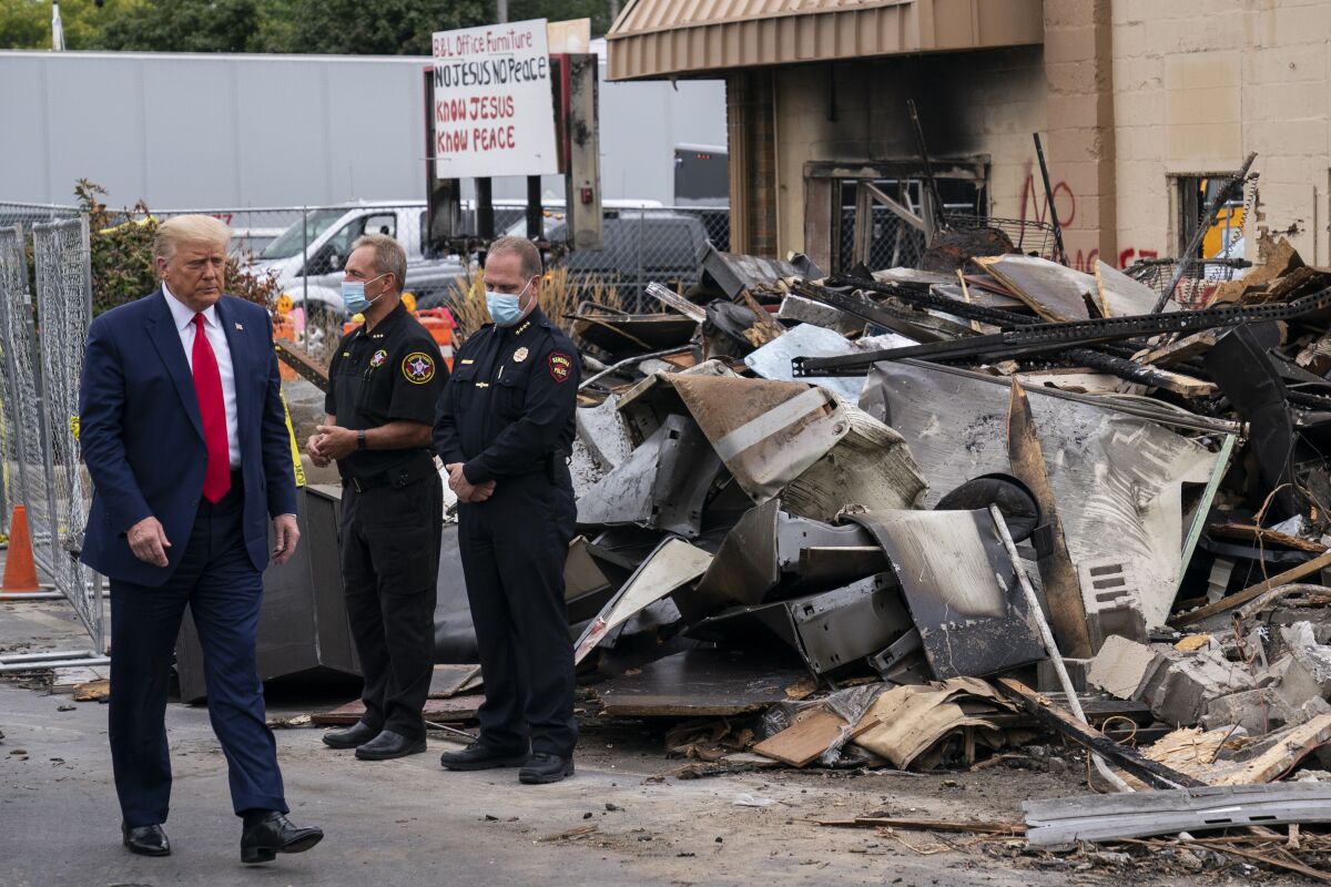 President  Trump tours an area damaged during demonstrations in Kenosha, Wis.