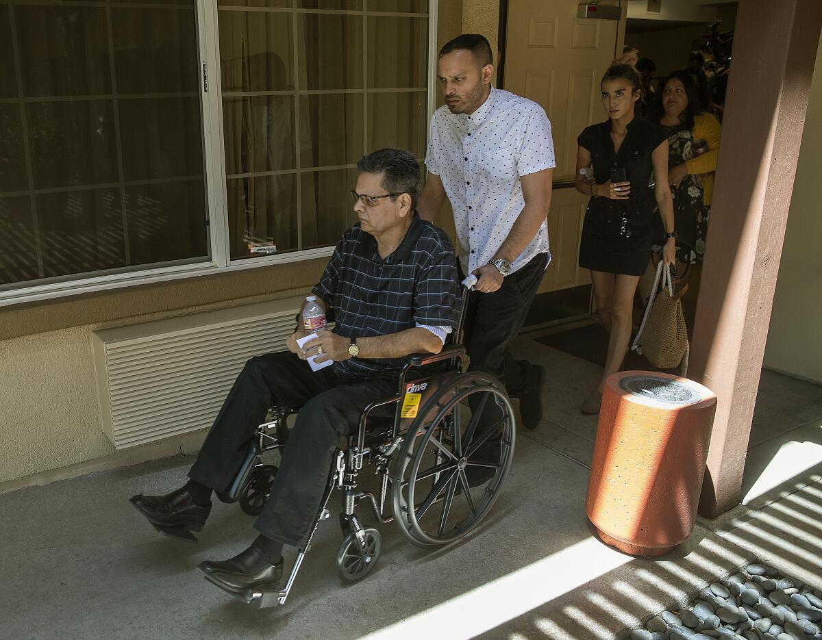 Russell French, left, and his son Kevin leave a news conference in Corona. French was wounded in the Costco shooting.