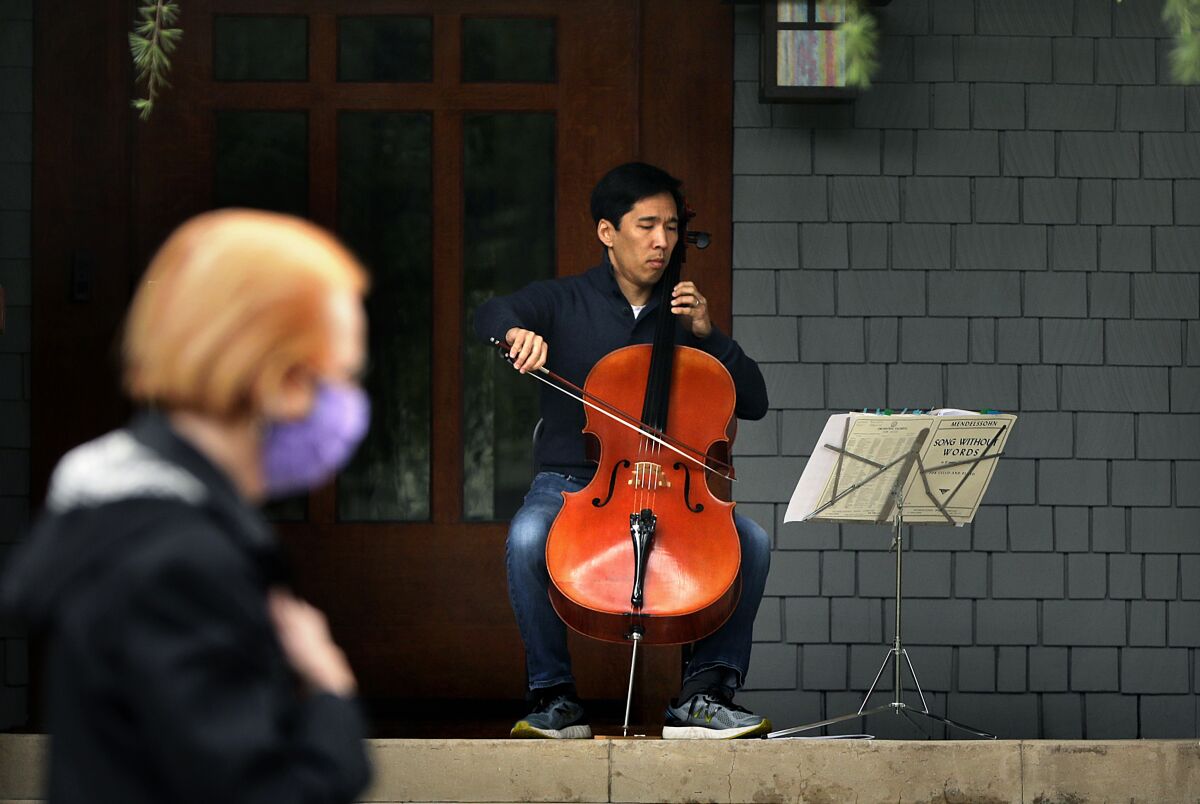Beong-Soo Kim plays cello on the porch of his home in Pasadena.
