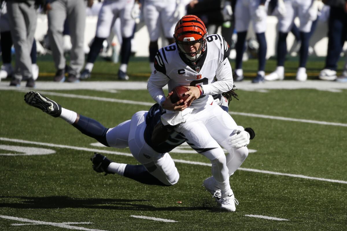 Cincinnati Bengals quarterback Joe Burrow breaks away from Tennessee's Jadeveon Clowney during Sunday's game.