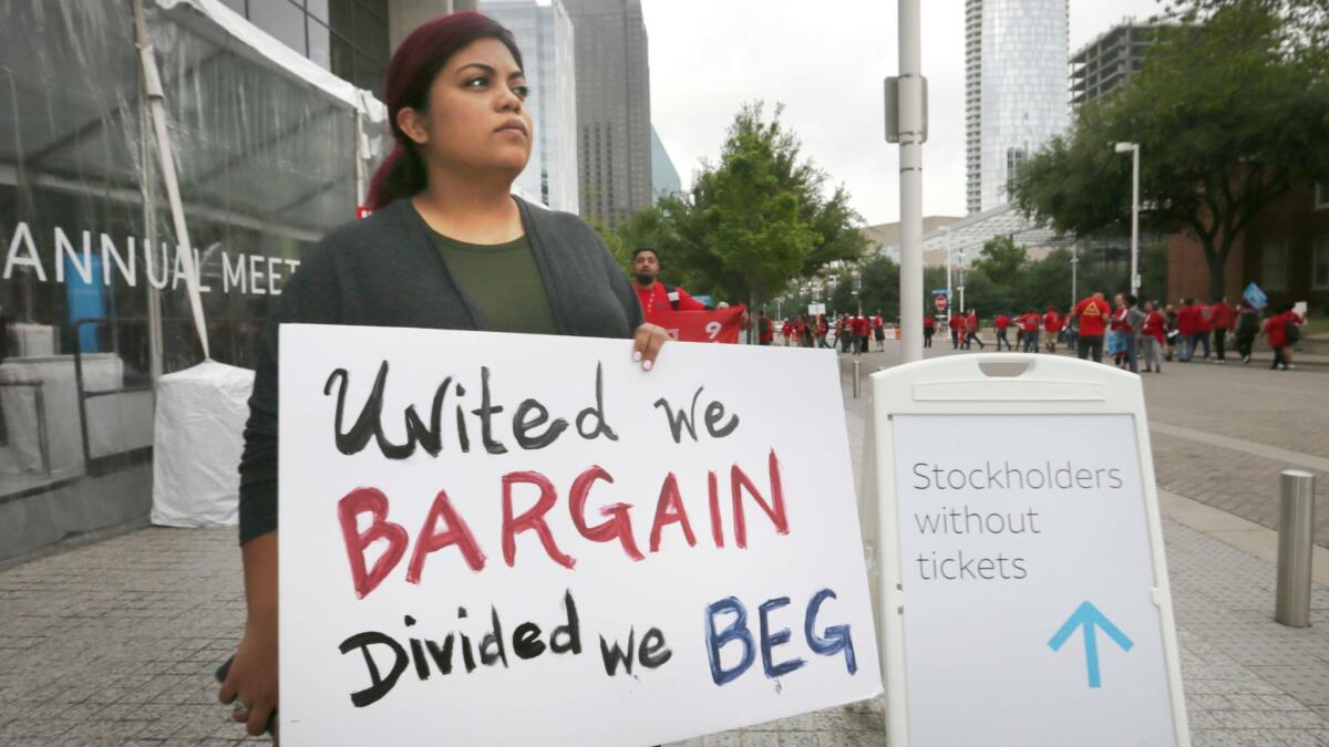 Kristian Hernandez, a member of the CWA, protests outside the AT&T shareholders meeting in Dallas last month.