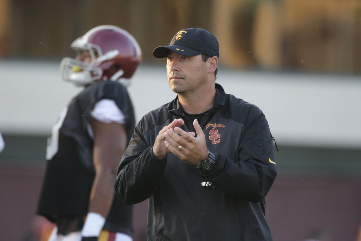 USC Coach Steve Sarkisian watches his players train Wednesday during a practice. The Trojans open their season against Fresno State on Aug. 30 at the Coliseum.