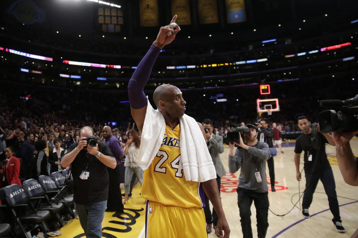 Lakers forward Kobe Bryant waves goodbye to fans after a game against the Clippers.