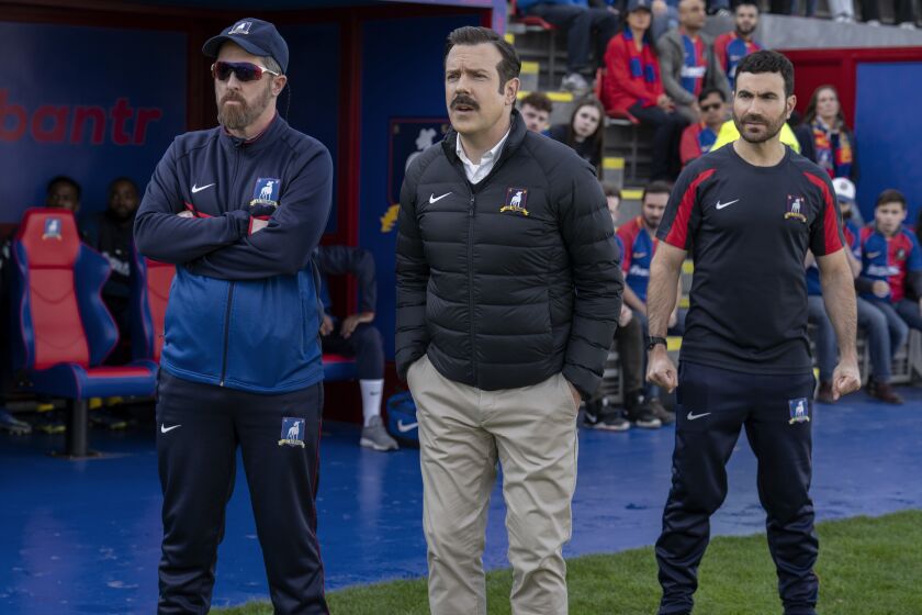 This image released by Apple TV shows Brendan Hunt, from left, Jason Sudeikis and Brett Goldstein in the season three finale episode of "Ted Lasso." (Colin Hutton/Apple TV via AP)