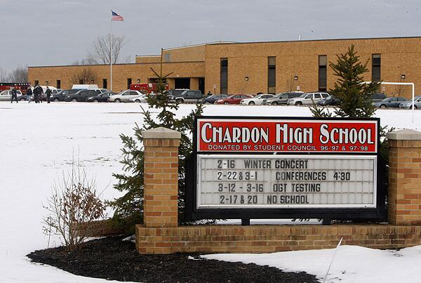 Emergency vehicles at Chardon High School in Chardon, Ohio. A gunman opened fire inside the high school's cafeteria at the start of the school day, killing three students and wounding two, officials said. A suspect is in custody.