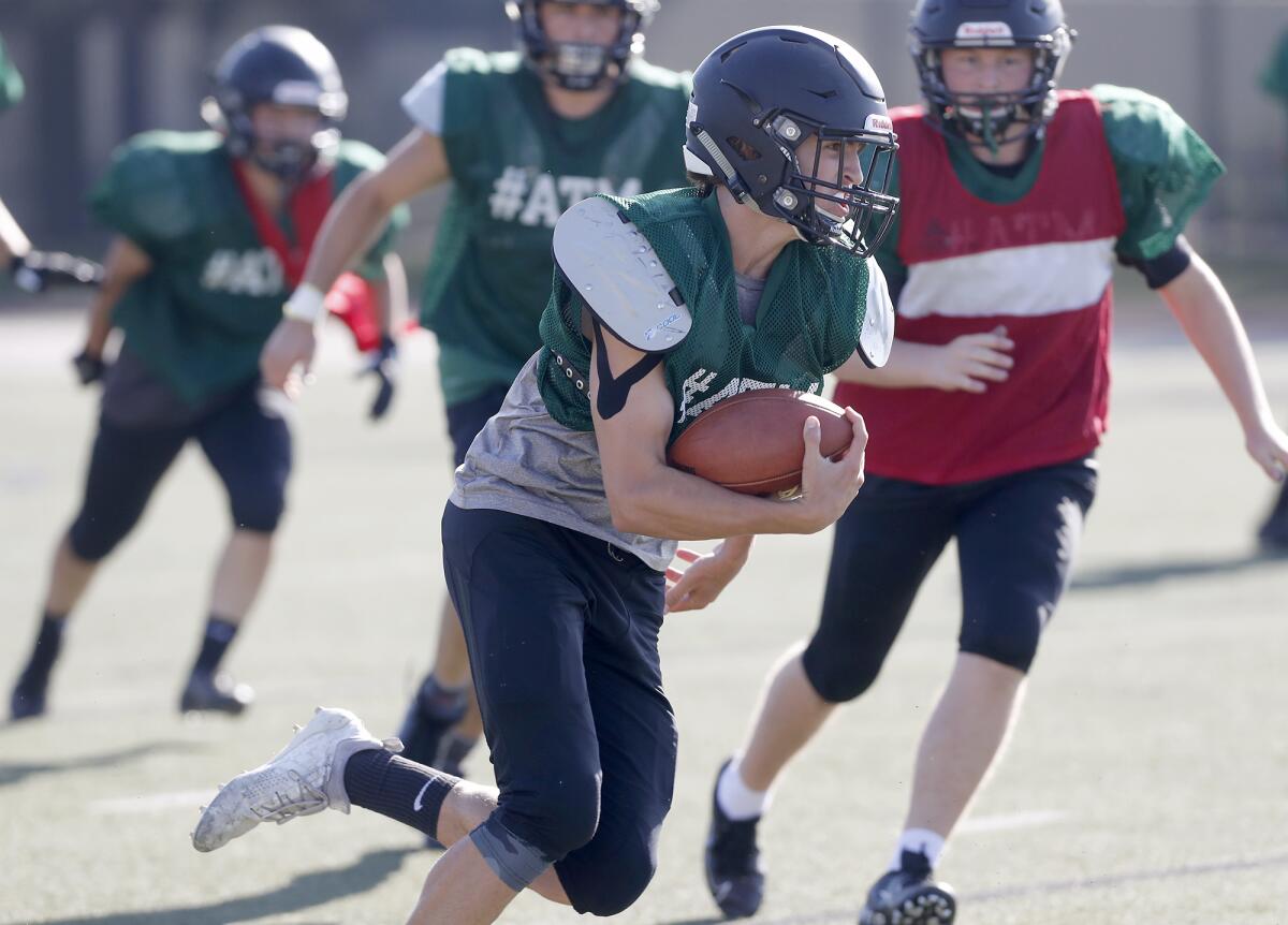 Sage Hill quarterback Van Freund, shown running with the ball during practice on Wednesday, is back after missing most of last season.