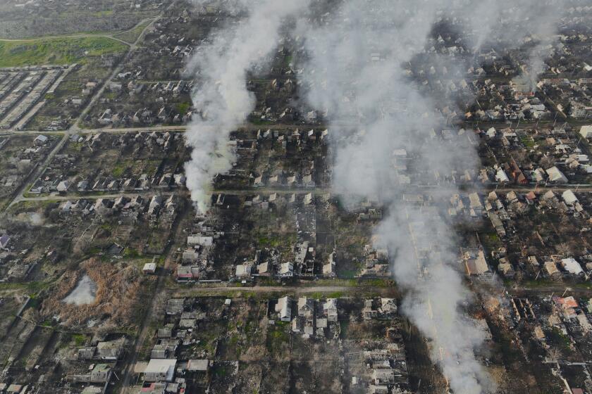 Smoke billows after Russian attacks in the outskirts of Bakhmut, Ukraine, Tuesday, Dec. 27, 2022. (AP Photo/Libkos)