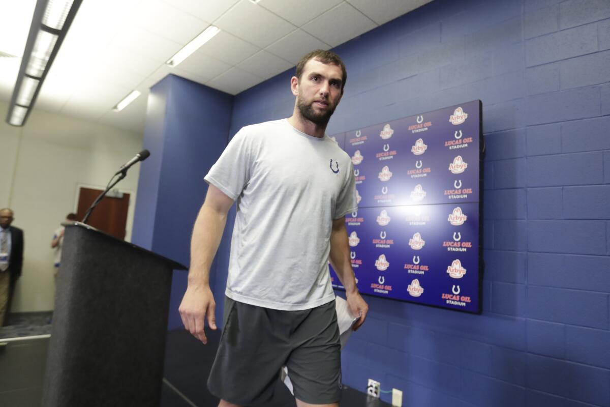 Indianapolis Colts quarterback Andrew Luck leaves the podium after announcing his retirement at a news conference on Saturday.