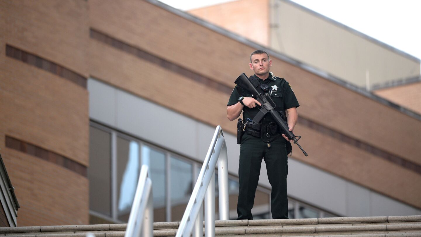 A police officer stands guard outside the Orlando Regional Medical Center after a fatal shooting at nearby Pulse nightclub in Orlando, Fla., on Sunday.