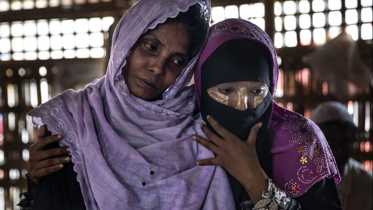 Salema Hatu, left, is held by her daughter Setera at a Doctors Without Borders clinic in Bangladesh on Monday. They are among the thousands of Rohingya who have fled Myanmar.