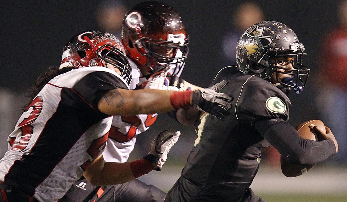 As Narbonne's quarterback in 2012, Troy Williams is chased by Centennial's KImo Sherlin, left, and Xavier Hughes.