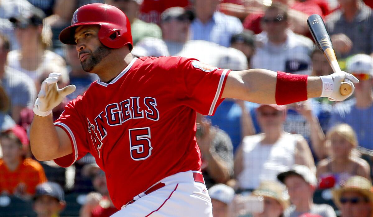 The Angels' Albert Pujols follows through on a base hit against the Seattle Mariners during the first inning of a spring training game on March 15 in Tempe, Ariz.