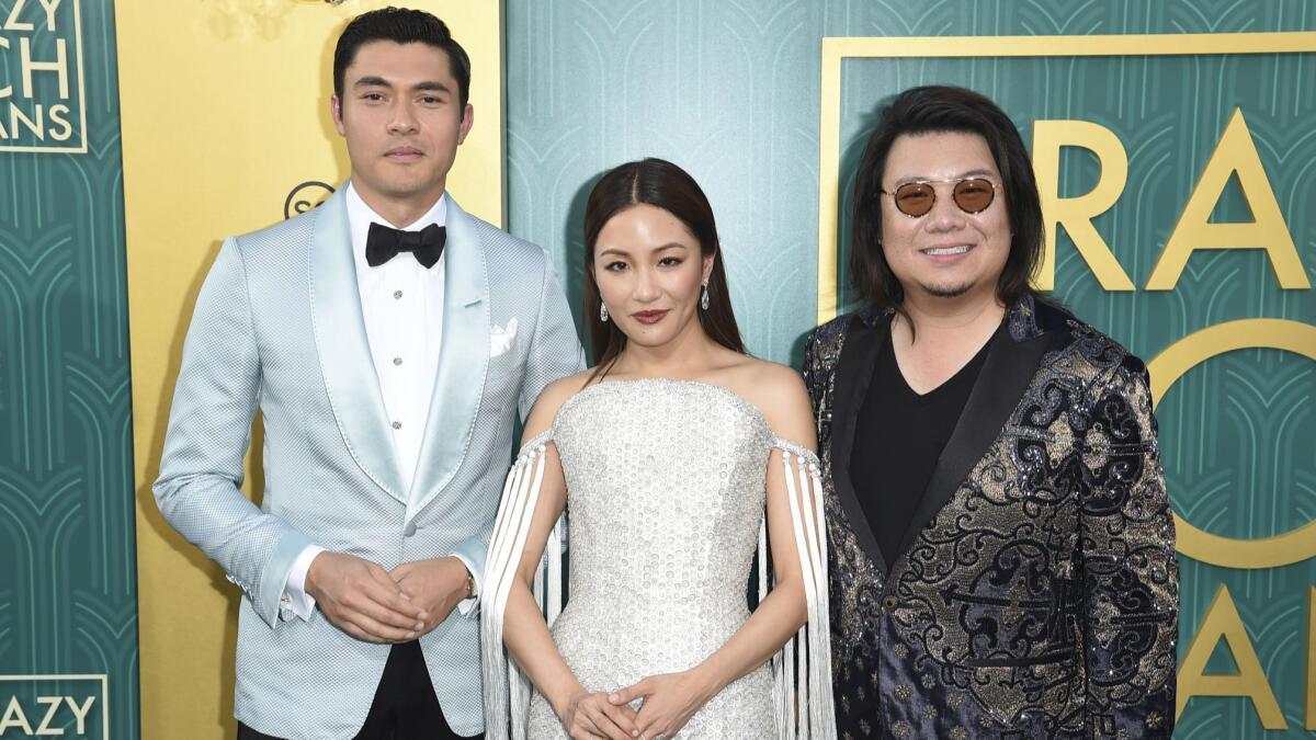 Kevin Kwan, right, with Henry Golding and Constance Wu, two stars of the movie based on his book "Crazy Rich Asians."
