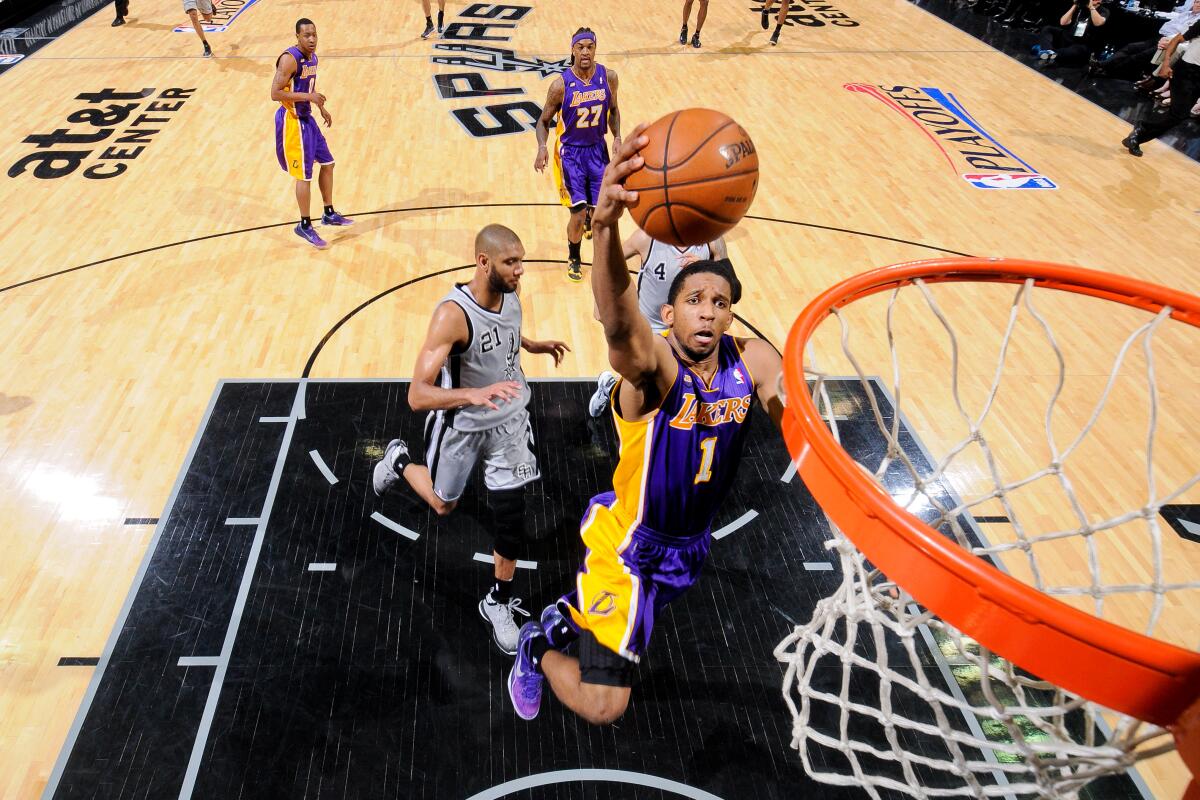 Lakers' Darius Morris drives to the basket during a basketball game against the Spurs