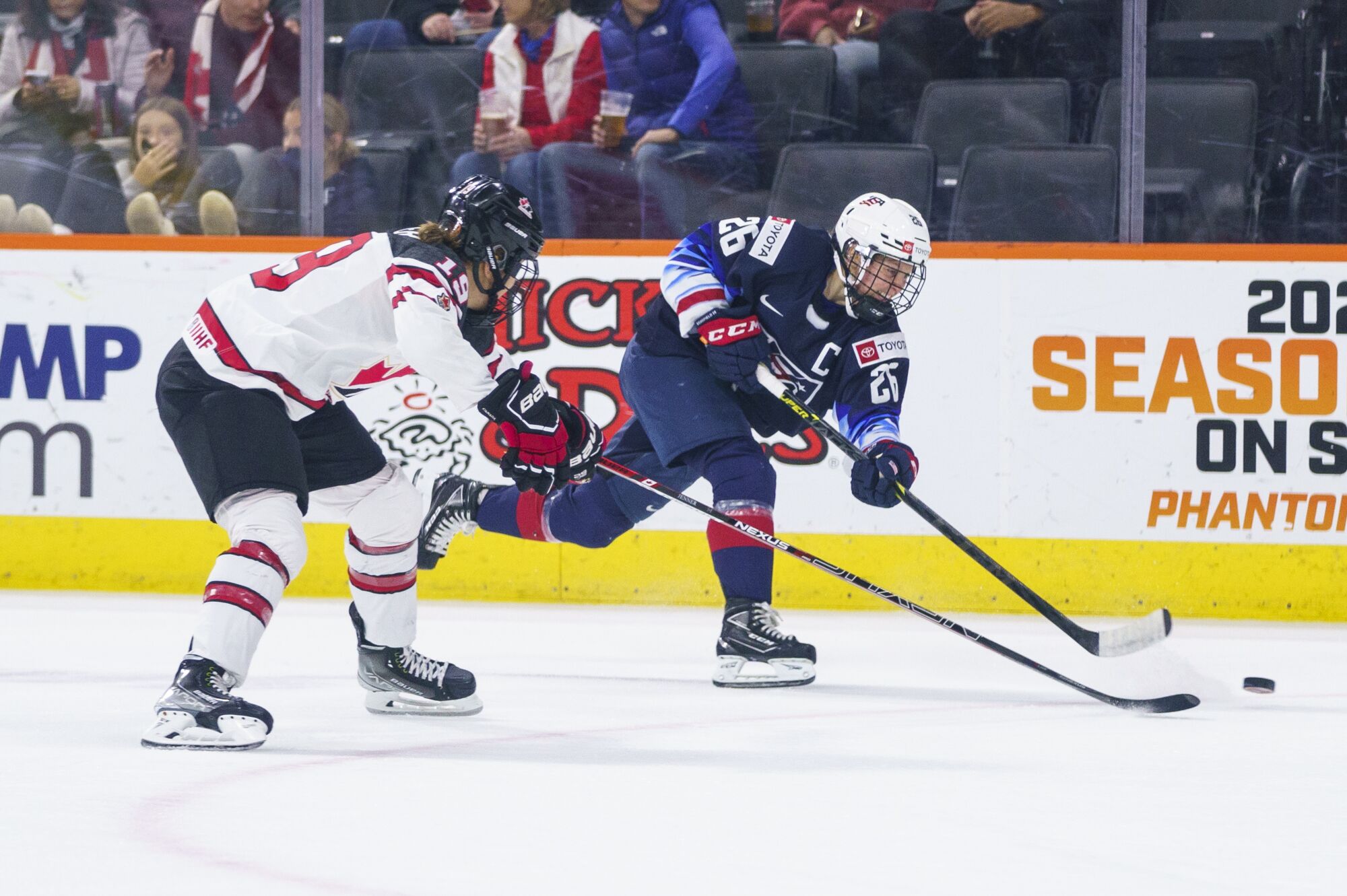 U.S. forward Kendall Coyne Schofield, right, shoots the puck next to Canada's Brianne Jenner during a game in October.
