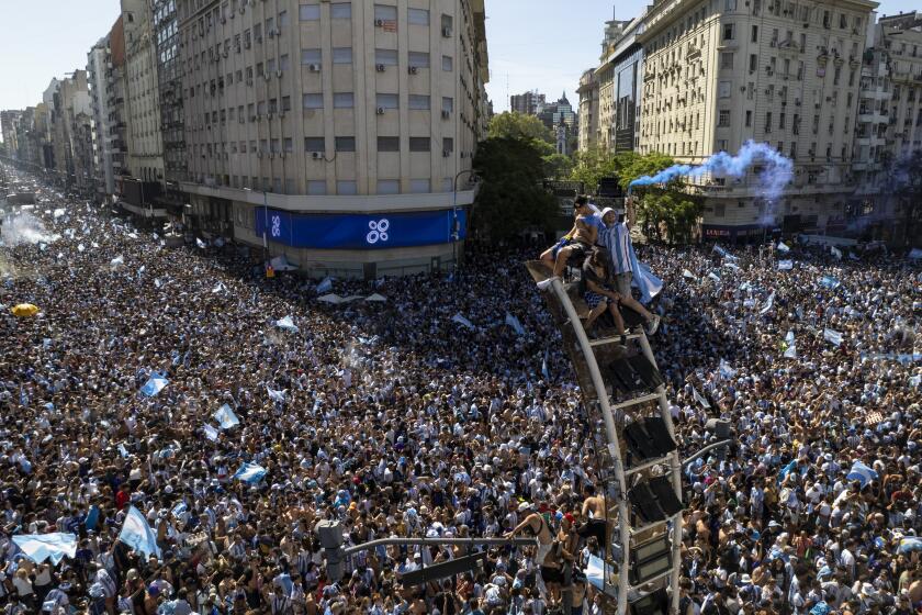 Argentine soccer fans descend on the capital's Obelisk to celebrate their team's World Cup victory over France, in Buenos Aires, Argentina, Sunday, Dec. 18, 2022. (AP Photo/Rodrigo Abd)