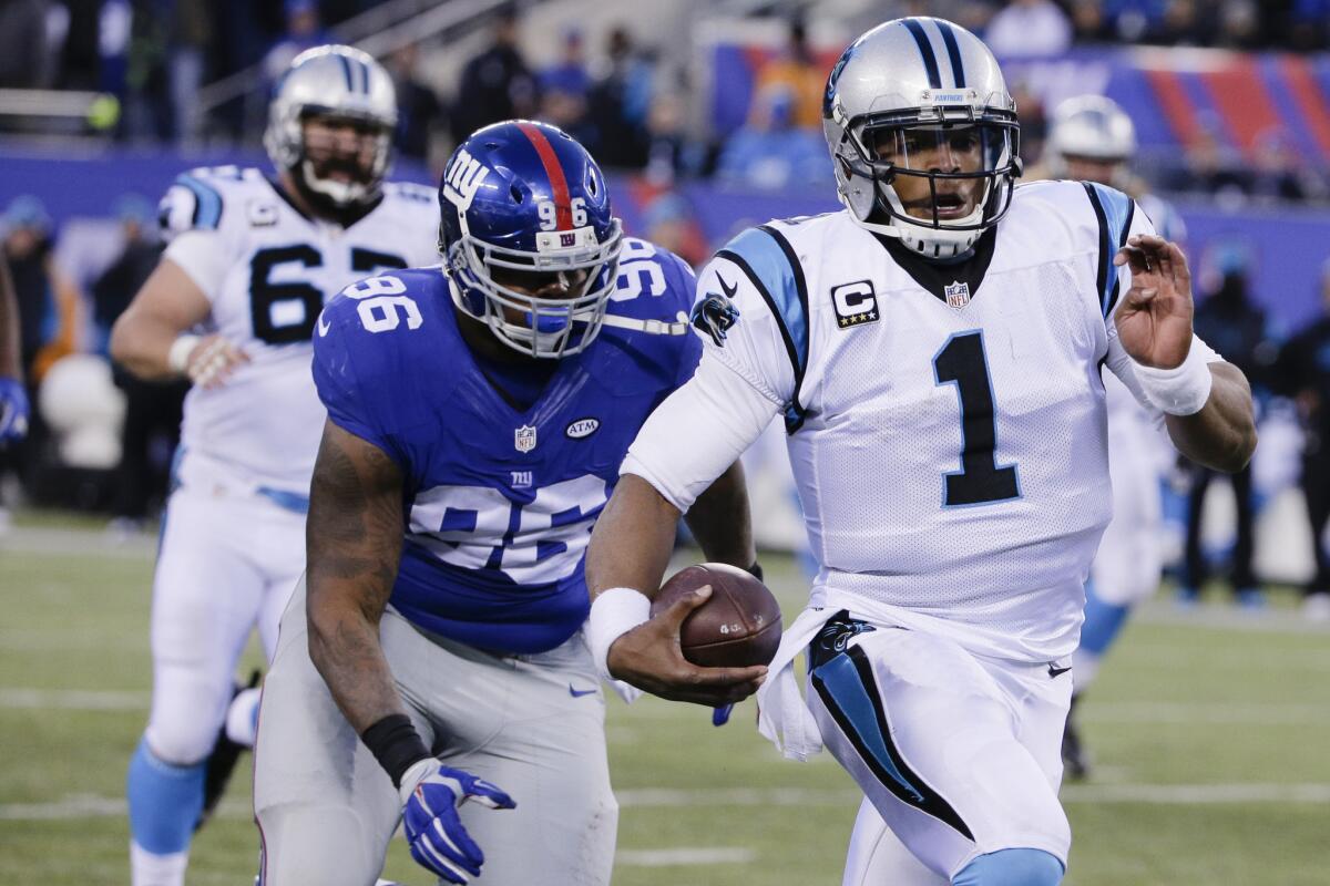 Panthers quarterback Cam Newton (1) runs away from Giants defensive lineman Jay Bromley (96) during the second half.