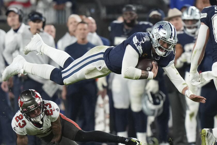 Dallas Cowboys quarterback Dak Prescott (4) dives over Tampa Bay Buccaneers cornerback Sean Murphy-Bunting.