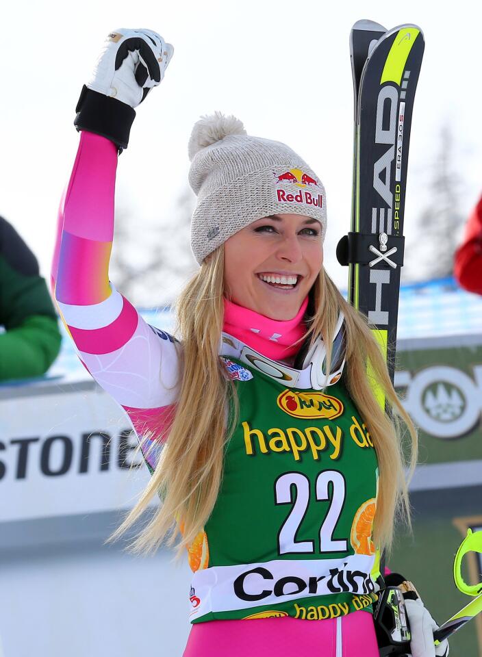 Lindsey Vonn celebrates after winning an alpine ski, women's World Cup super-G, in Cortina d'Ampezzo, Italy, Monday, Jan. 19, 2015. (AP Photo/Armando Trovati)