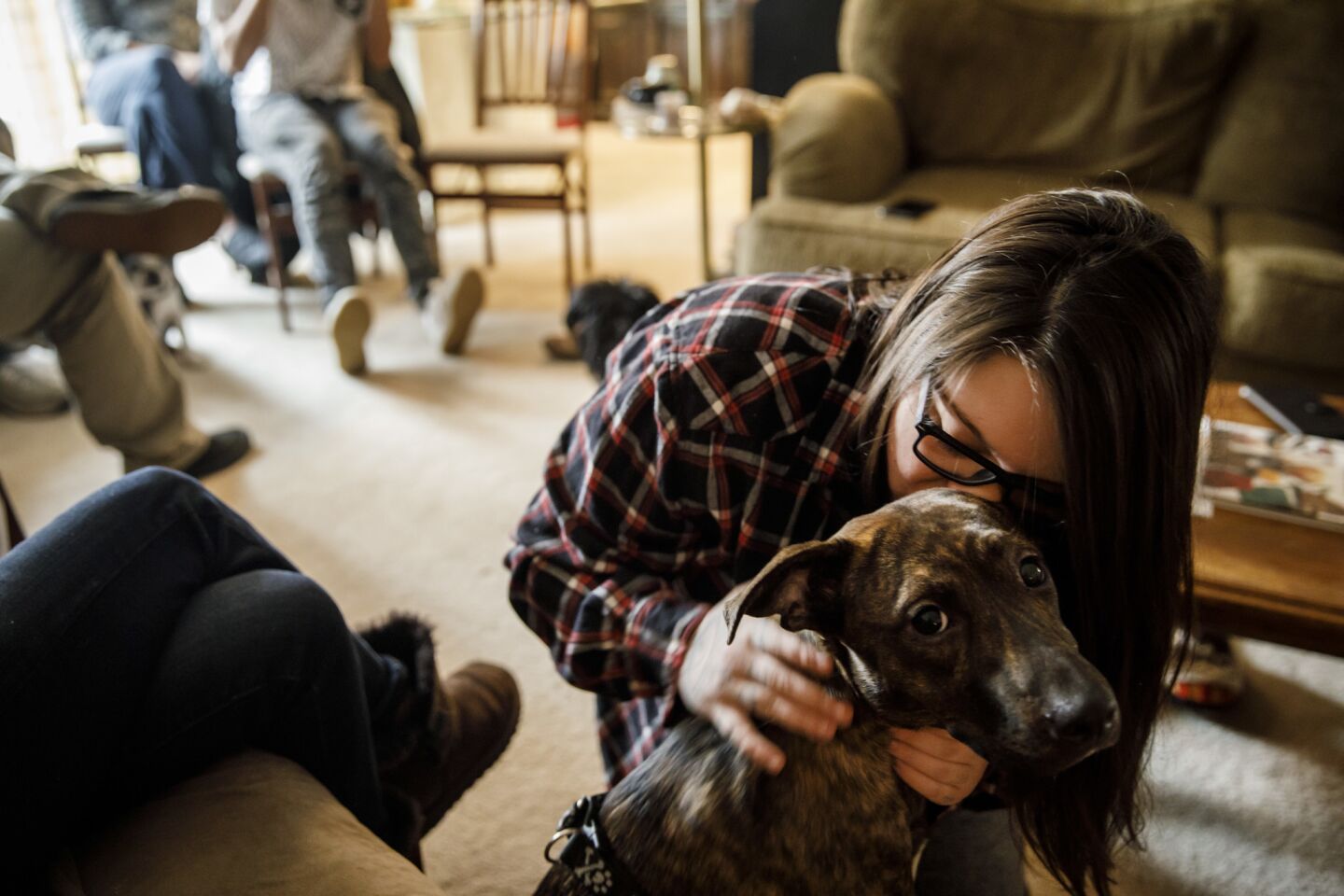 Alexandria Wilson, 21, kisses her dog Harley, after they both escaped the Camp Fire in Paradise, Calif.