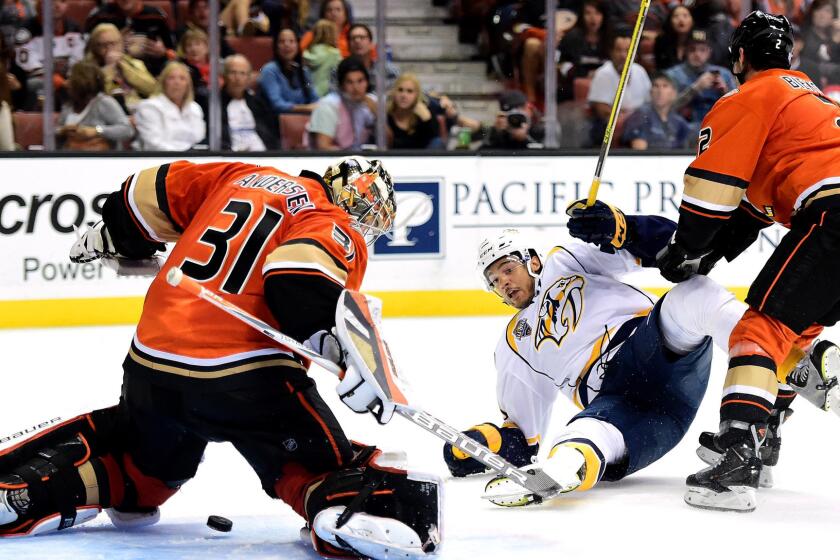 Ducks goalie Frederik Andersen blocks a shot as Predators defenseman Seth Jones is knocked to the ice by defenseman Kevin Bieksa in the second period Sunday.