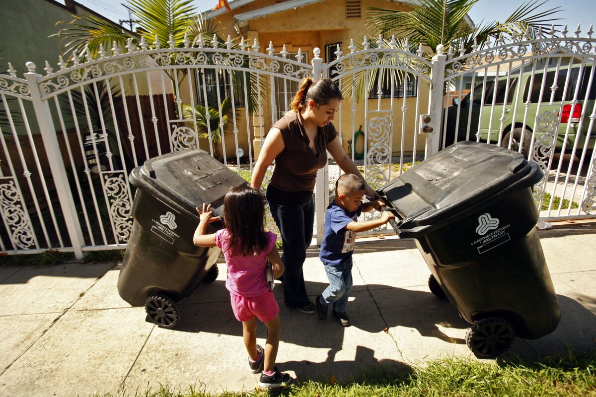 Crystal Garcia, 26, with her children Melonie, 4, left and Jesse, 3, right, is concerned about soil testing in the yards of neighbors that showed elevated levels of lead in their Boyle Heights neighborhood on March 12, 2014.