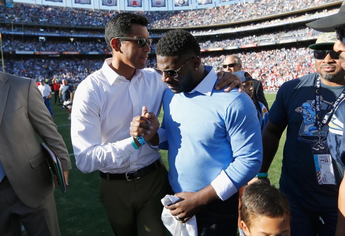 Former Chargers linebacker Donnie Edwards, left, congratulates LaDanian Tomlinson  after Tomlinson's number was retired in 2015. 