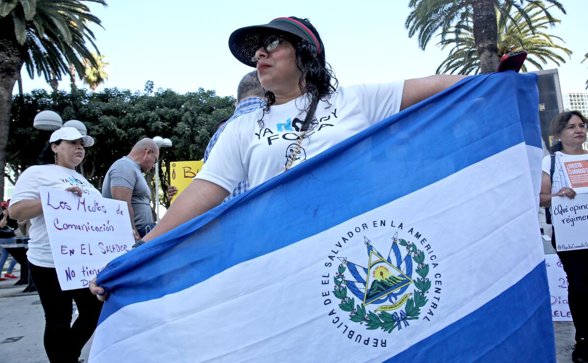 A person holds a blue and white flag.
