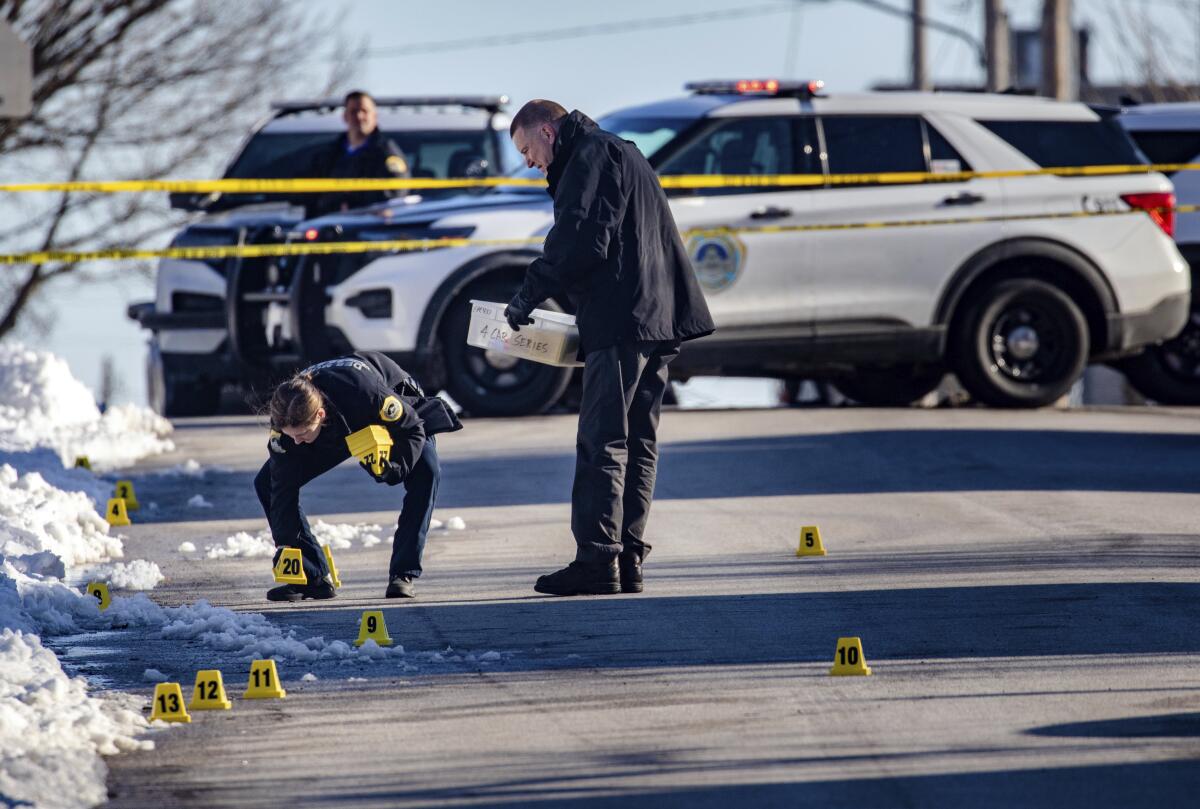FILE - Police investigate a shooting outside of East High School in in Des Moines, Iowa, on March 7, 2022. A third teenager charged with murder in a drive-by shooting death of a 15-year-old boy outside a Des Moines high school in March has agreed to plead guilty to lesser crimes. The plea agreement accepted by a state court judge on Monday, Oct. 3, 2022, may allow Gumaro Marquez-Jacobo, 18, to avoid prison time for charges related to the March 7 death of 15-year-old Jose Lopez. (Zach Boyden-Holmes/The Des Moines Register via AP, File)