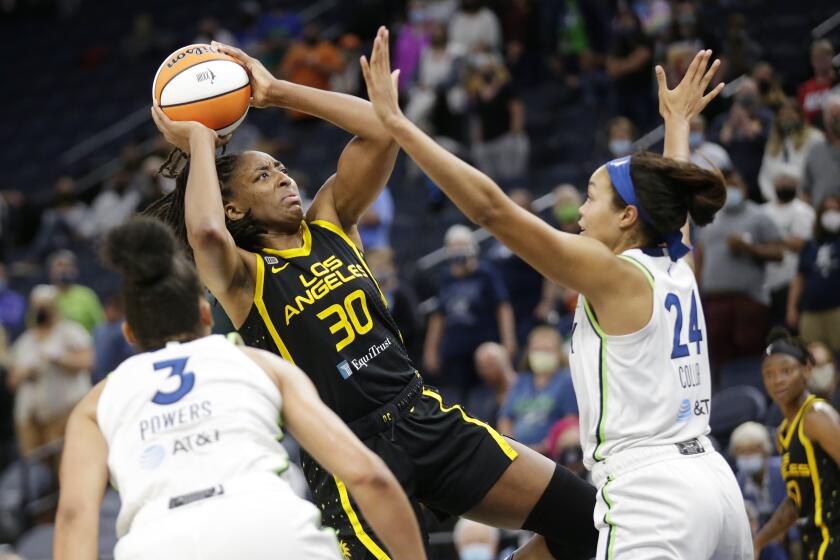 Los Angeles Sparks forward Nneka Ogwumike (30) shoots over Minnesota Lynx forward Napheesa Collier (24) and forward/guard Aerial Powers (3) in the third quarter of a WNBA basketball game, Thursday, Sept. 2, 2021, in Minneapolis. (AP Photo/Andy Clayton-King)