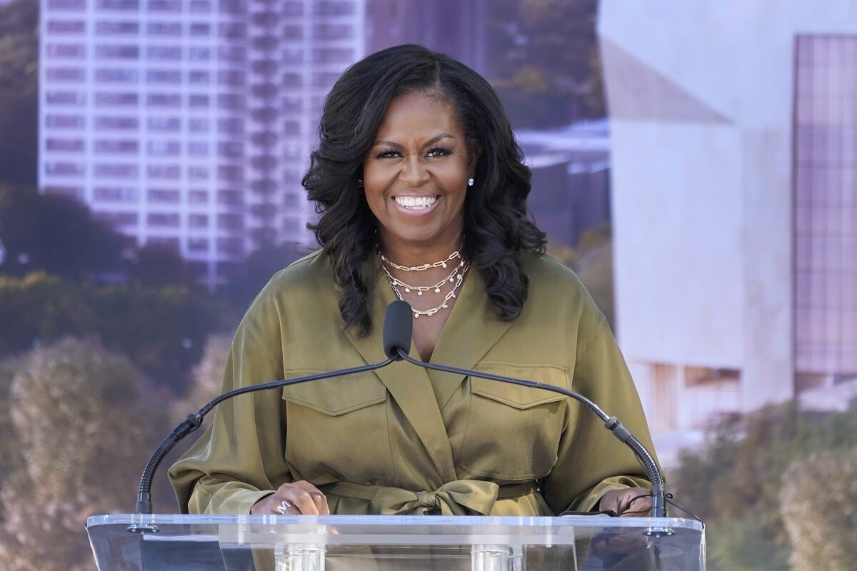 FILE - Former first lady Michelle Obamad smiles as she speaks during a groundbreaking ceremony for the Obama Presidential Center, Sept. 28, 2021, in Chicago. Michelle Obama will deliver the keynote address at a democracy summit sponsored by a national, nonpartisan voting organization she helped create, the group announced Wednesday, April 20, 2022. (AP Photo/Charles Rex Arbogast, File)