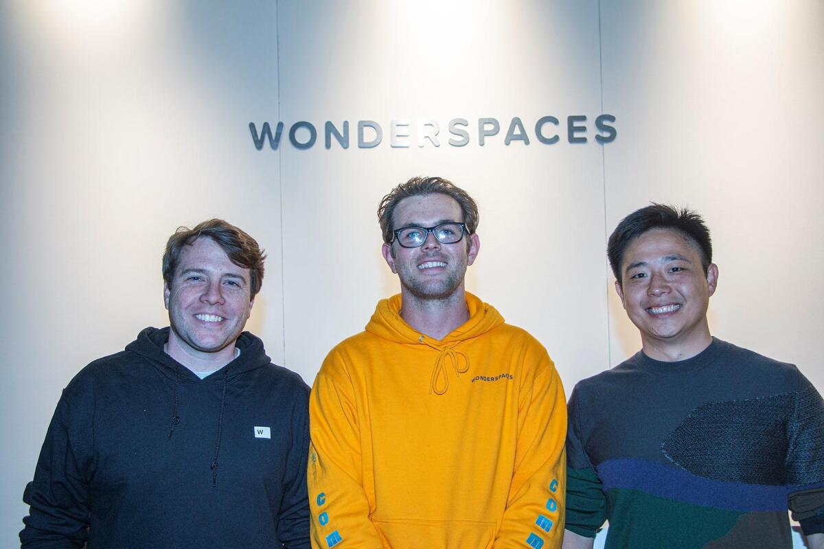 At the June 6th preview of Wonderspaces 2019, co-founders Patrick Charles and Jason Shin pose with Jordan Hill, general manager of their 100-person San Diego team, between them.