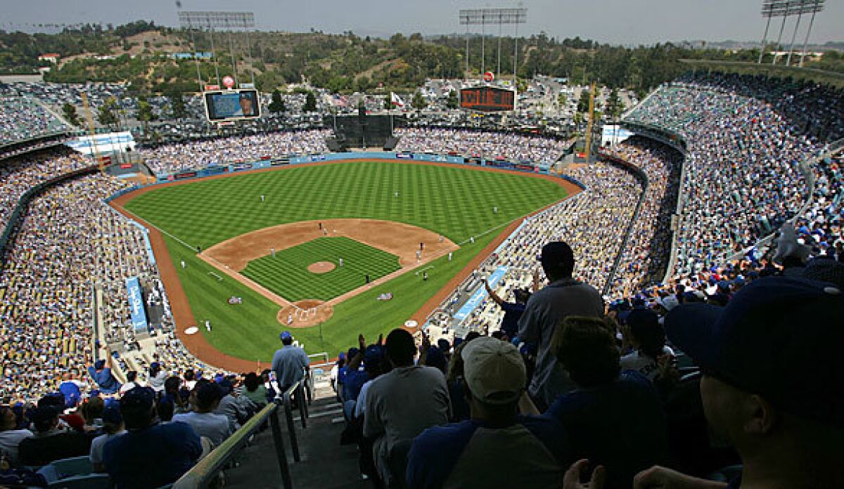 Fans cheer at a sold-out opening day game at Dodger Stadium.