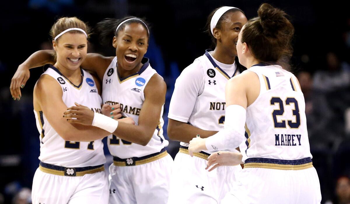 From left, Notre Dame guard Hannah Huffman, Lindsay Allen, Jewell Loyd and Michaela Mabrey celebrate after defeating Stanford, 81-60, in the women's regional semifinal NCAA basketball Tournament in Oklahoma City on Friday.