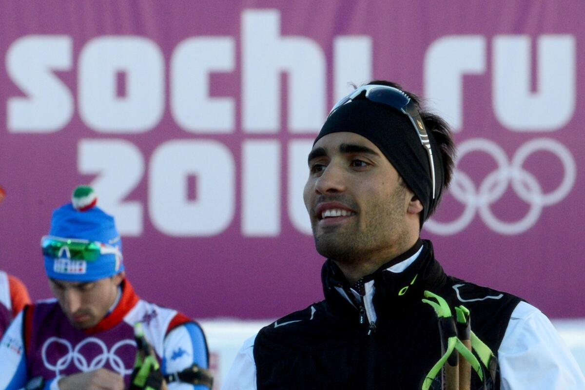 France's biathlete Martin Fourcade (R) attends a training session at the Laura Cross Country Skiing and Biathlon Centre in Rosa Khutor, near Sochi, on February 5, 2014. The Sochi Olympic Winter Games 2014 will run from February 7 to 23.