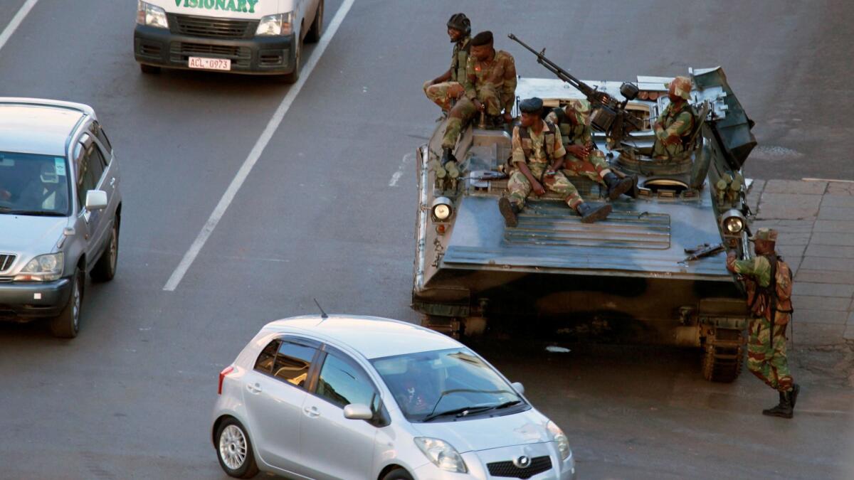 Soldiers in a military vehicle are posted outside the office of President Robert Mugabe in Harare, Zimbabwe, on Nov. 15, 2017.