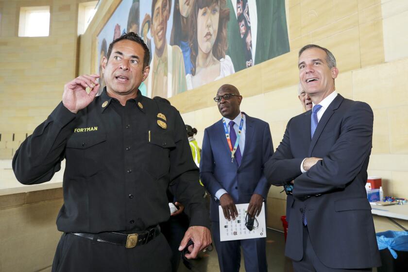 Los Angeles, CA - June 08: Los Angeles City Assistant Fire Chief Ellsworth Fortman, left, and Mayor Eric Garcetti at the inauguration of a COVID-19 vaccination site at Union Station on Tuesday, June 8, 2021 in Los Angeles, CA. (Irfan Khan / Los Angeles Times)