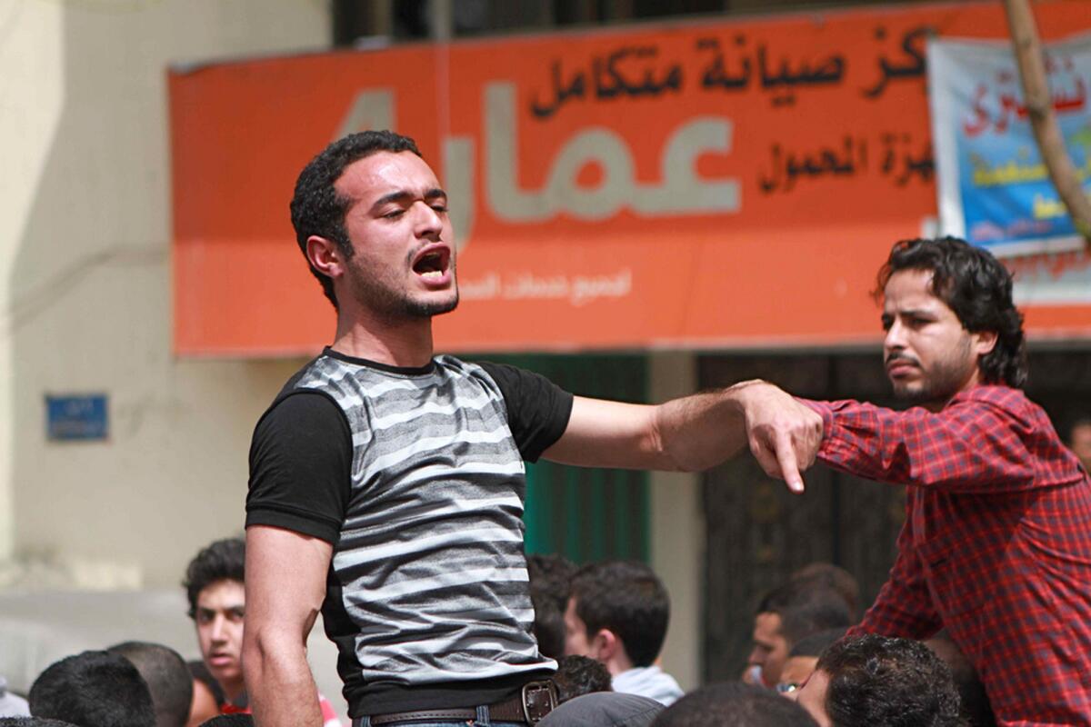 In this April 1, 2011, photo, activist Ahmed Douma chants slogans during a march to Cairo's Tahrir Square demanding the prosecution of members of former President Hosni Mubarak's government. A lawyer for Douma and two other prominent youth activists said his clients were beaten Monday by guards before a hearing in the appeal of their prison sentences.