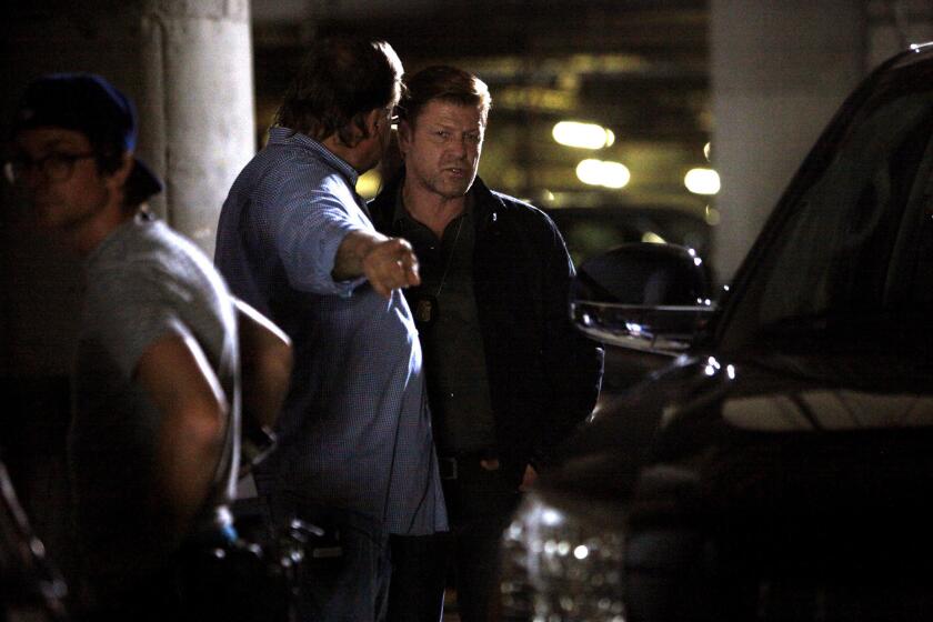 Director John Behring, second from left, directs Sean Bean, facing camera, during production of the new TNT series "Legends."