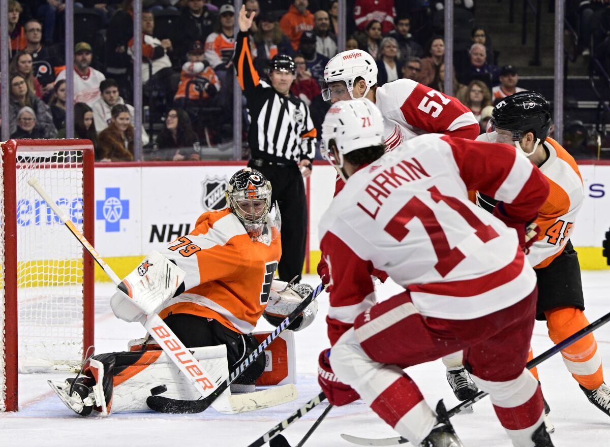 Philadelphia Flyers goaltender Carter Hart (79) makes a save on a shot from Detroit Red Wings' David Perron (57) during the third period of an NHL hockey game, Saturday, March 25, 2023, in Philadelphia. (AP Photo/Derik Hamilton)