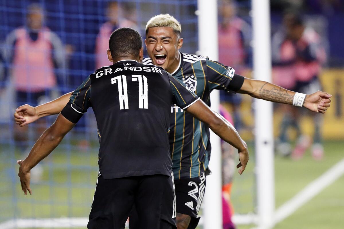 The Galaxy's Julian Araujo, right, celebrates a goal by Samuel Grandsir during the second half July 30, 2021.