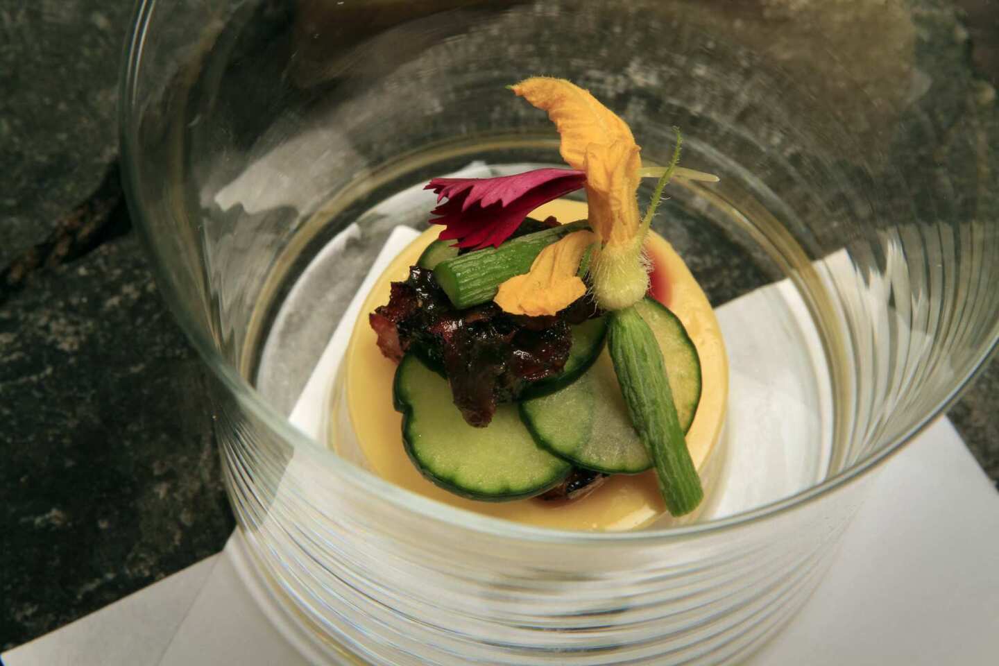 Japanese egg custard tofu, with grilled freshwater eel, cucumbers and a garnish of baby cucumber with its yellow blossom.