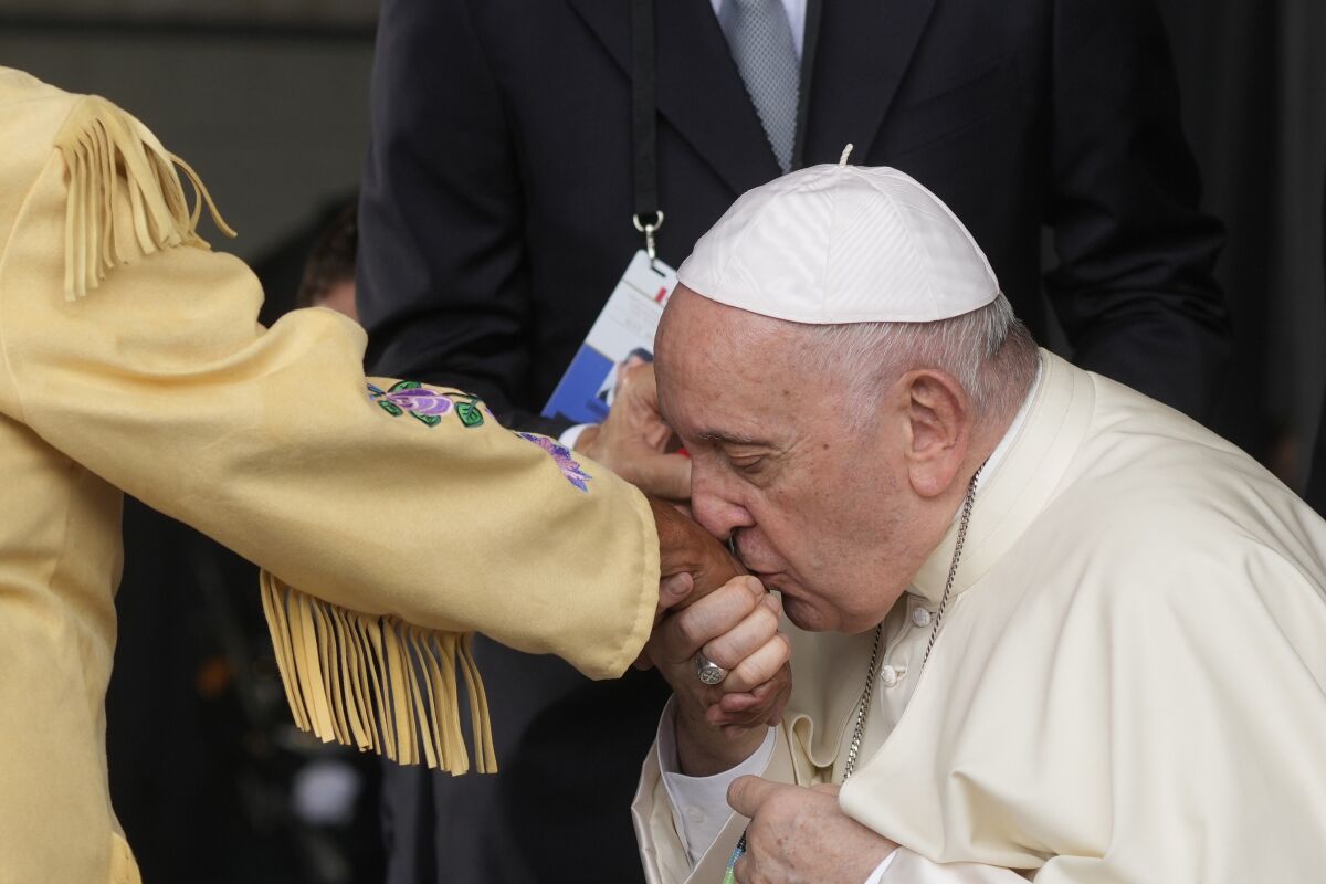 Pope Francis kisses the hand of a Canadian Indigenous woman as he arrives at Edmonton International Airport on July 24. 
