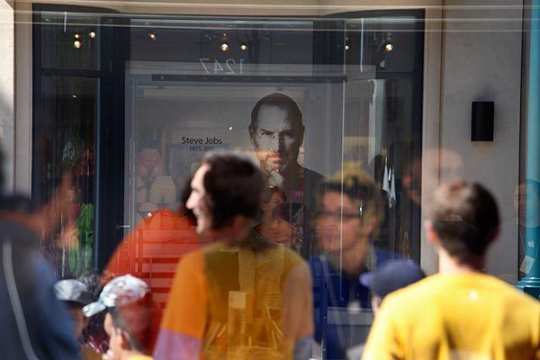 A photo of Steve Jobs is displayed on the main screen of the Apple store on the Third Street Promenade in Santa Monica.
