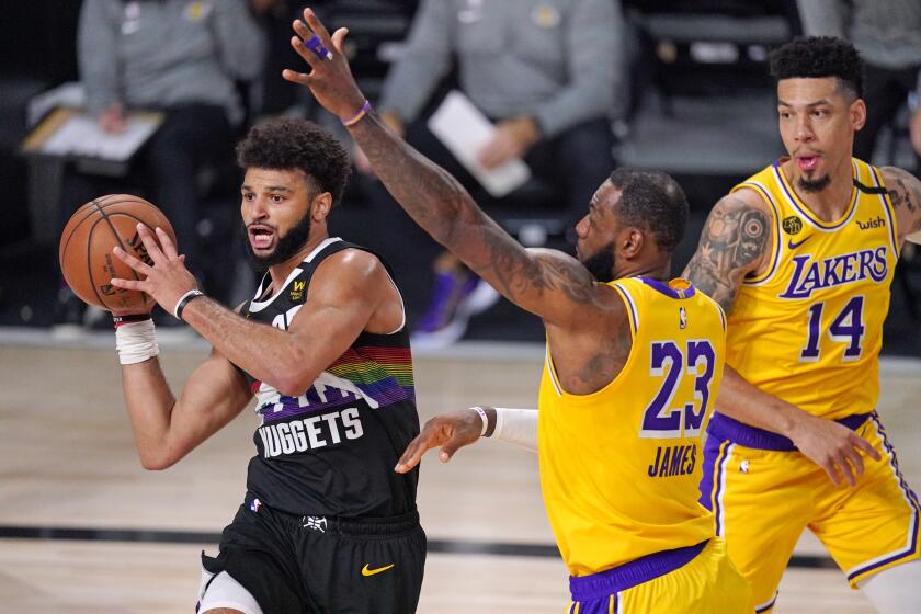 Denver Nuggets' Jamal Murray, left, is defended by Los Angeles Lakers' LeBron James (23) during the second half of an NBA conference final playoff basketball game Thursday, Sept. 24, 2020, in Lake Buena Vista, Fla. (AP Photo/Mark J. Terrill)