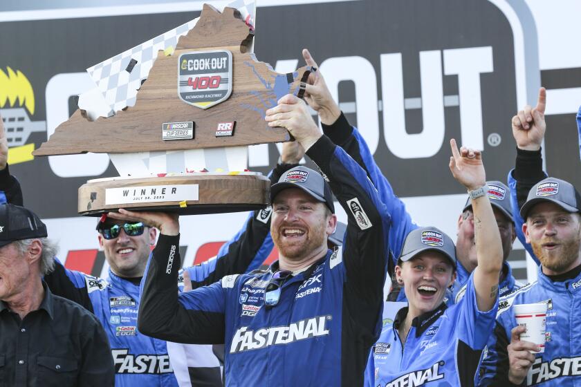 Chris Buescher raises the Cook Out 400 Trophy in Victory Lane after winning a NASCAR Cup Series.